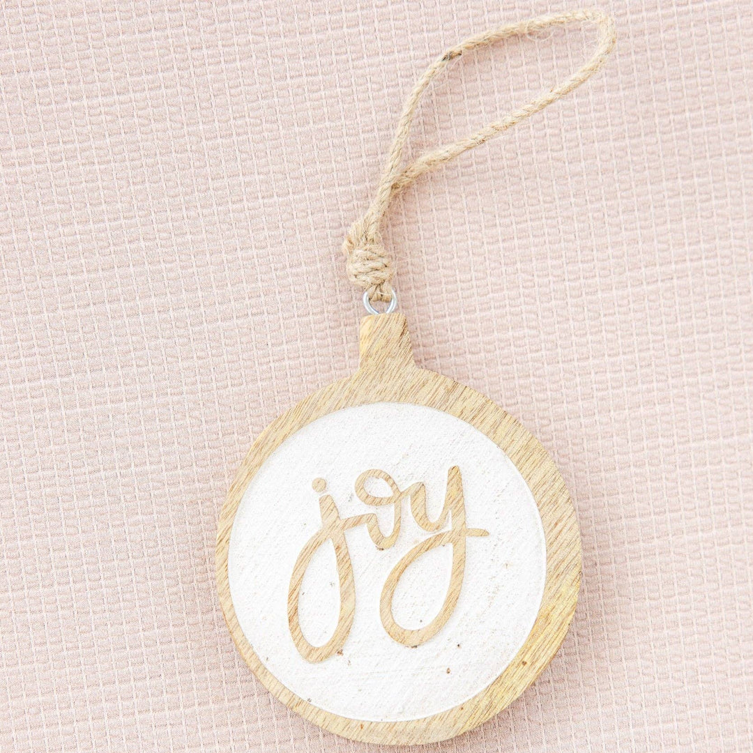 Decorative ornament with 'joy' text on a beige background