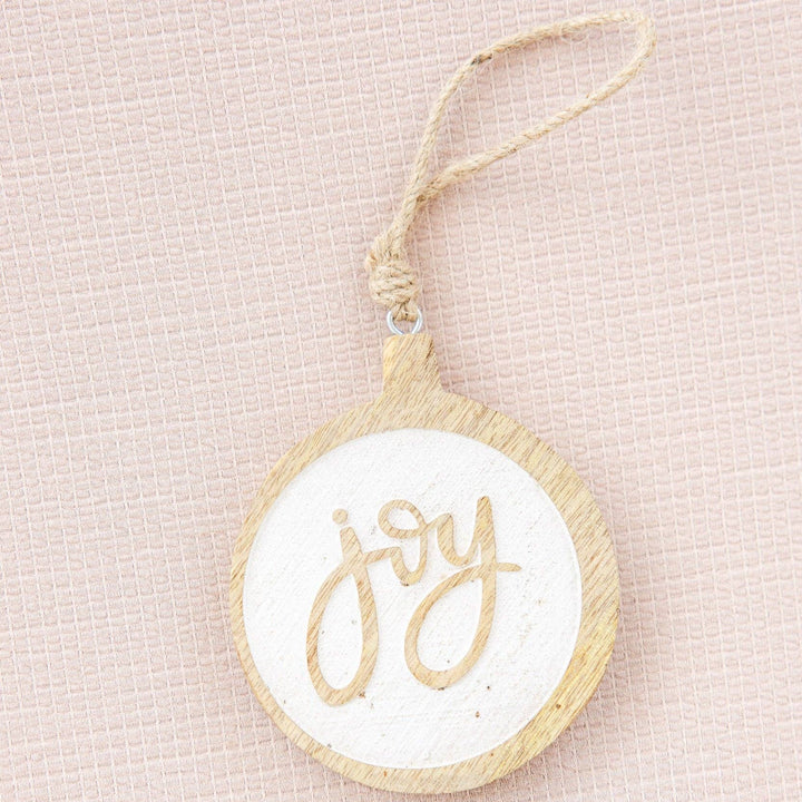 Decorative ornament with 'joy' text on a beige background