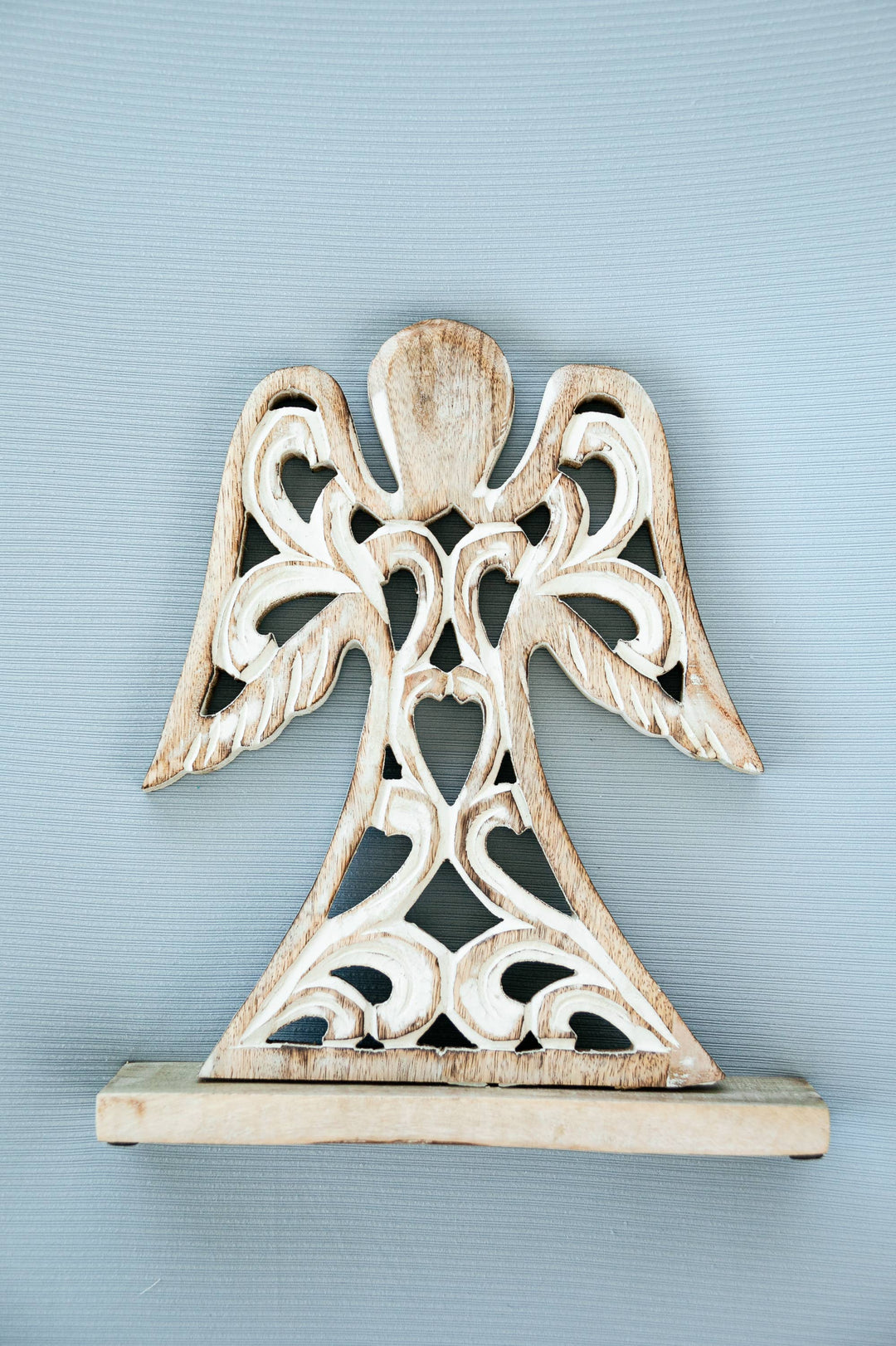 Decorative angel sculpture on a light blue background