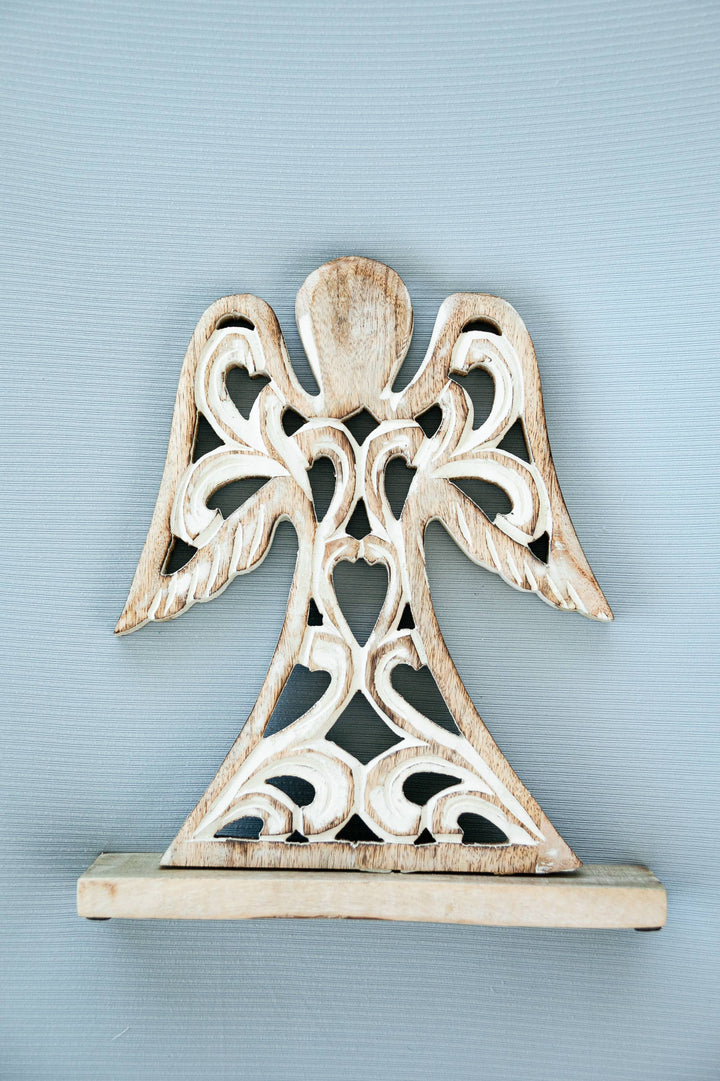 Decorative angel sculpture on a light blue background